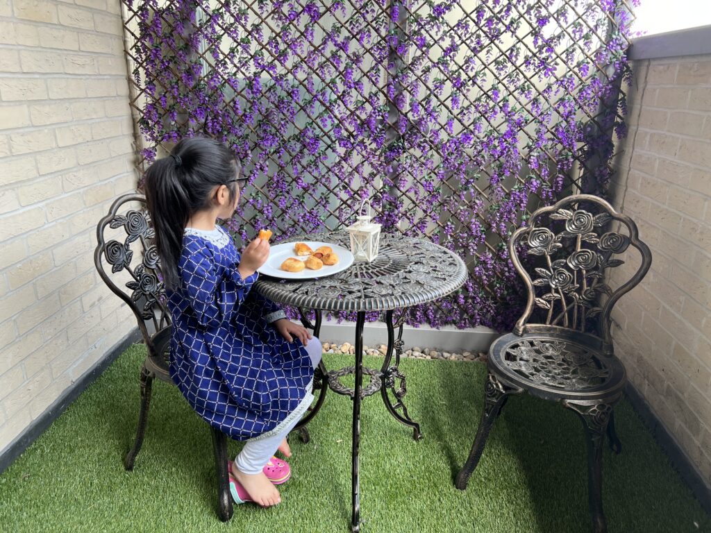 Picture of Miss A eating lunch on the balcony